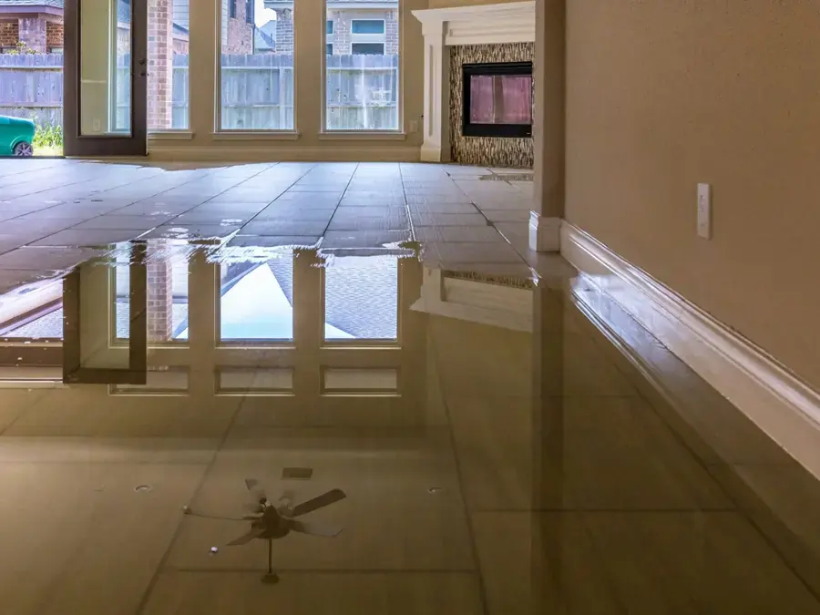 Standing water across a tile floor in a flooded Federal Way living room