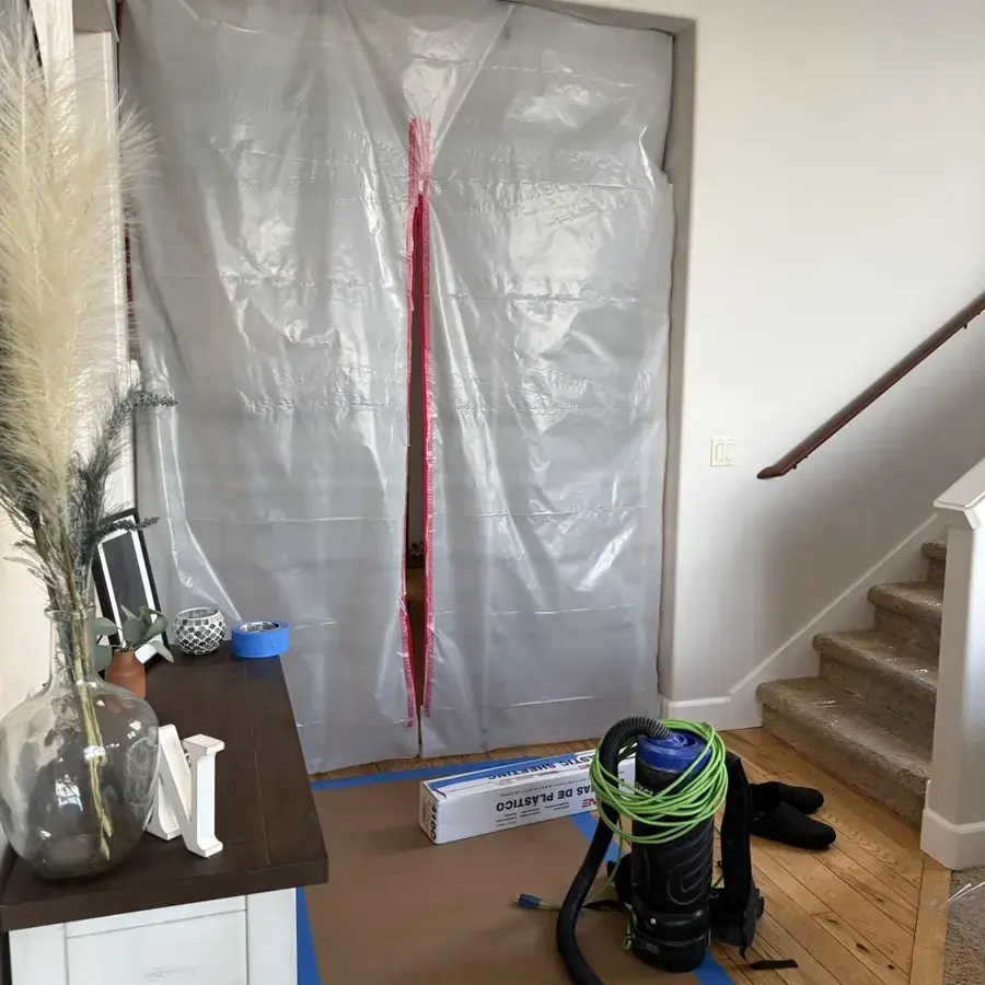 Plastic containment and a HEPA vacuum set up during a Federal Way water cleanup