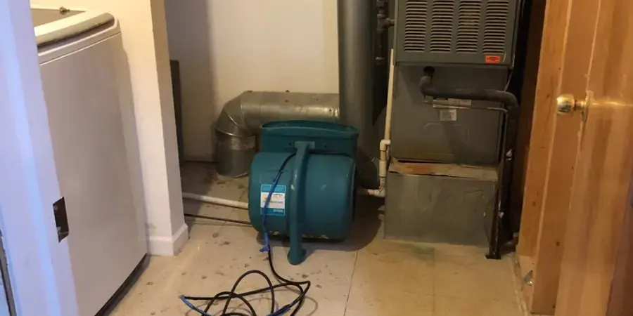 Air mover drying a laundry and furnace room after a leak in a Federal Way home