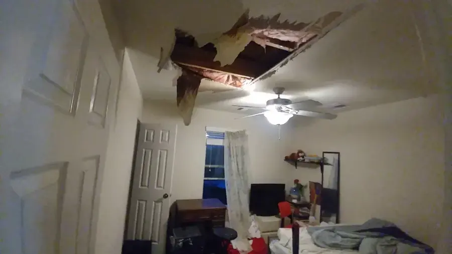 Collapsed bedroom ceiling after a leak from the unit above in a Federal Way apartment