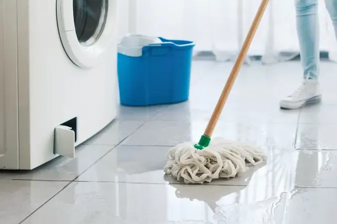 Water spreading across a tile floor from a leaking washing machine in Federal Way