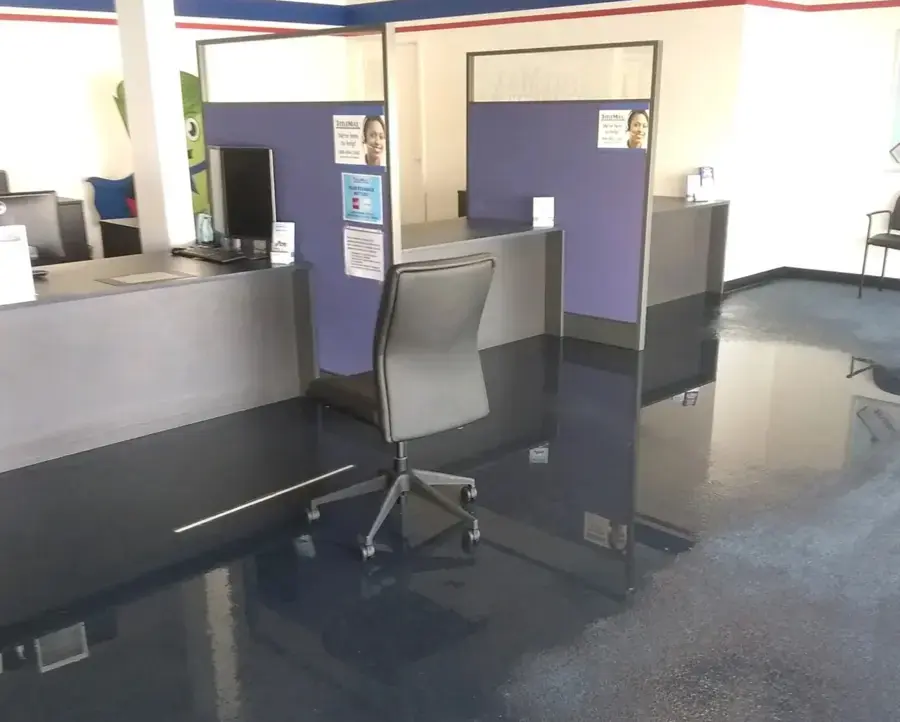 Standing water across the floor of a flooded Federal Way office
