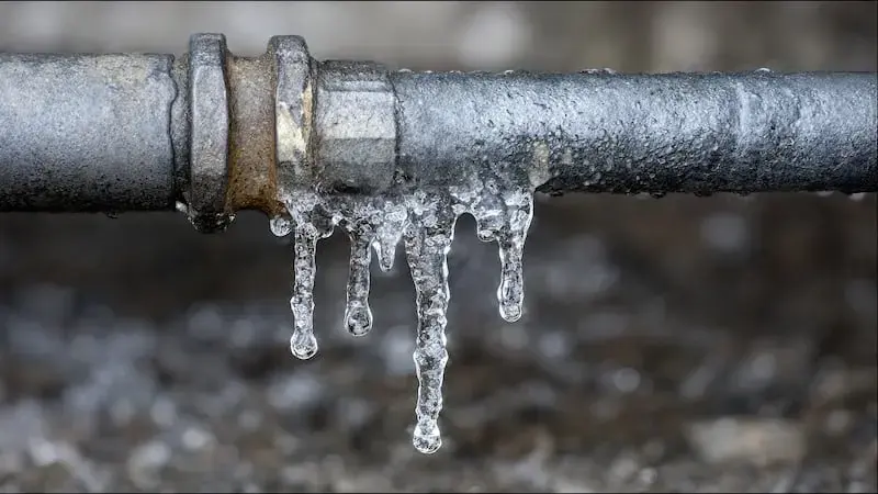 Icicles hanging from a frozen metal pipe during a Federal Way cold snap